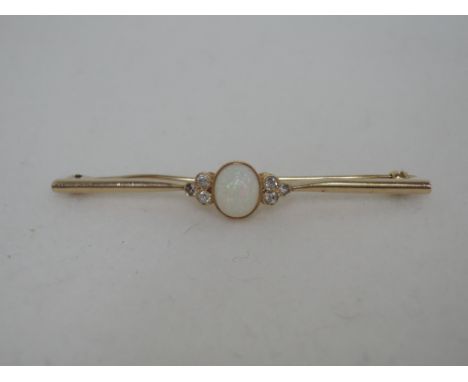 A yellow metal bar brooch having a central opal with three diamonds to each side, no marks tested as 9ct gold