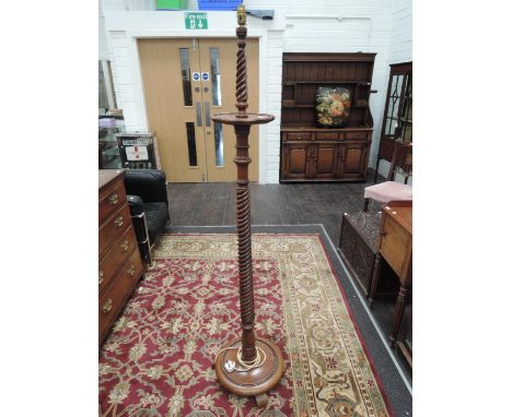 An early 20th century mahogany standard lamp having twist pedestal