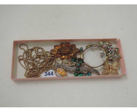 A small selection of costume jewellery brooches including a silver and marcasitte brooch, filligree, and diamante, a glass an