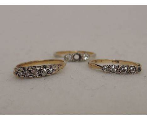 Two ladies dress rings each having five graduated diamonds on yellow metal loops stamped 18ct and a three stone diamond ring 