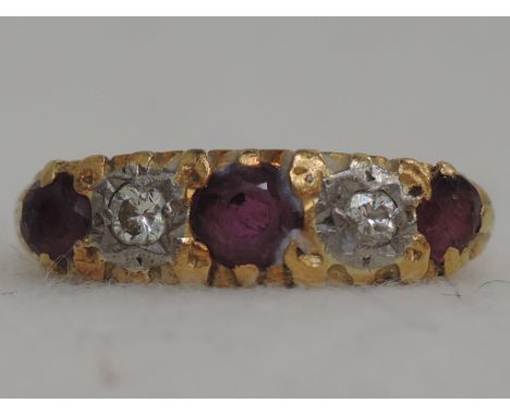 A ladies dress ring having three rubies interspersed by two diamondsin a moulded gallery mount on an 18ct gold loop