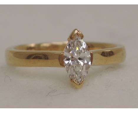 A ladies dress ring having a marquise cut diamond solitaire, approx .45ct in a collared mount on an 18ct gold loop