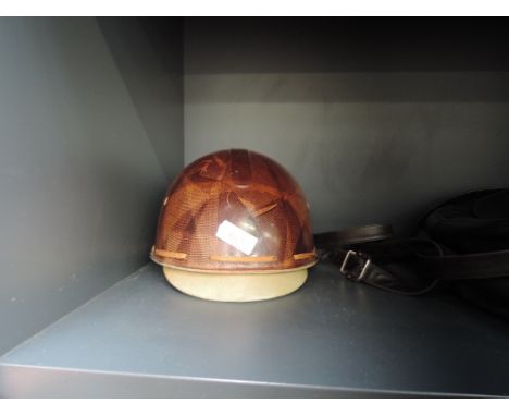A vintage riding helmet retailed by W Crook Gateshead