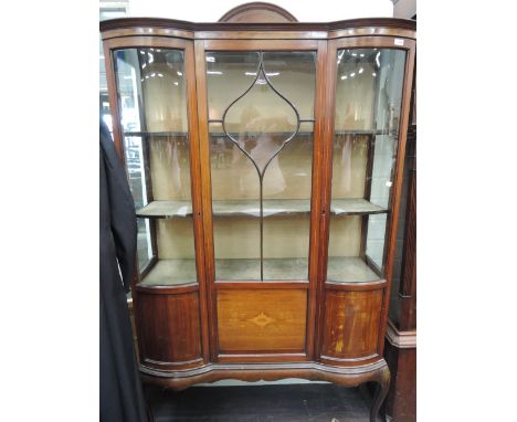 An Edwardian mahogany display cabinet having chequered line inlay decoration and double glass bow fronts, on cabriole legs