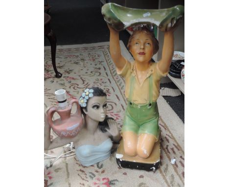 A mid 20th century plaster table lamp modelled as South Sea girl and a 1930's plaster figure, boy