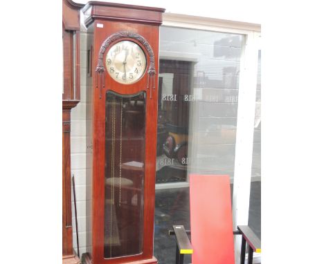 A 1920's stained maghogany grandmother clock having circular silvered dial, with glass trunk and plinth base