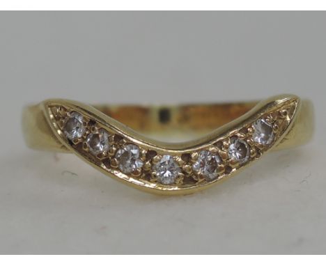 A ladies wish bone diamond eternity ring on an 18ct gold loop,  approx 2.7g