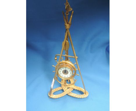 An early 20th century gilt painted novelty clock of marine design, modelled as suspended ship's wheel, flag pole, rope and oa