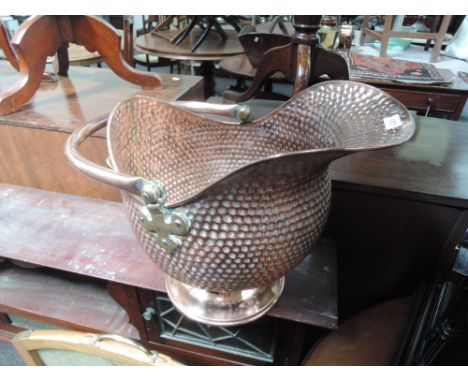 An early 20th century copper coal helmet of pimple design