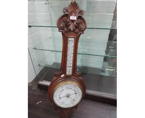 An early 20th century oak banjo aneroid barometer having thermometer scale
