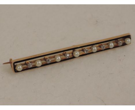 An Edwardian style yellow metal  bar brooch stamped 15ct of open rectangular form having cultured pearl and diamond decoratio