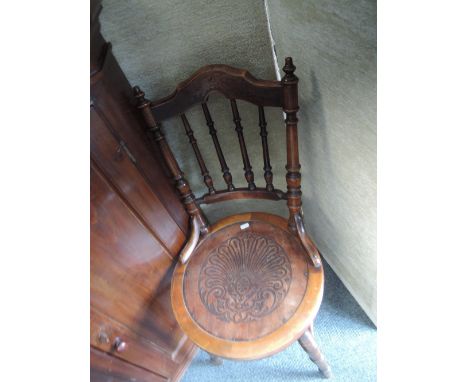 Three early 20th century stained frame bentwood chairs having spindle backs with circular embossed seats and ring turned legs