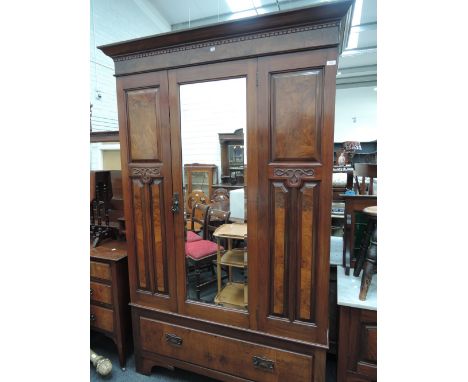 A late Victorian three piece bedroom suite comprising single mirror door wardrobe, tile back marble top washstand and dressin