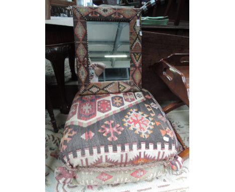 An early 20th century pouffe covered in Turkish style carpet, a similer framed mirror and a Turkish camel bag