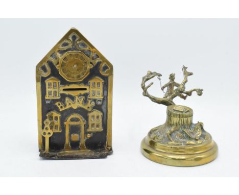 Victorian brass and cast iron money box in the form of a bank with a clock together together with cast brass tree stump inkwe