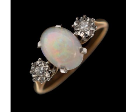 Opal and diamond three-stone ring, the oval opal cabochon approximately 6.5mm x 9mm, the diamonds illusion set in white metal