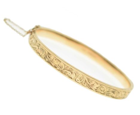 9ct gold hinged bangle, having engraved foliate decoration to the top section, 9.6g approx
