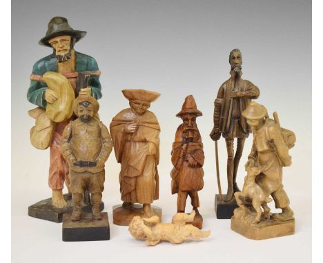 Small group of carved wooden figures, comprising: a huntsman with shotgun; probably Continental, a young boy feeding a goat, 