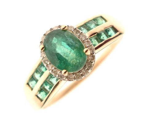 Emerald and diamond 9ct gold dress ring, the oval emerald (6mm x 8mm approx), within a border of small diamonds, the shoulder