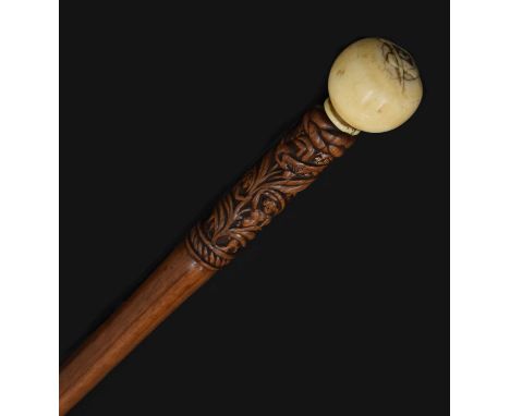 Early 20th century walking cane with ivory knop having carved Scottish masonic square and compass, the shaft having carved de