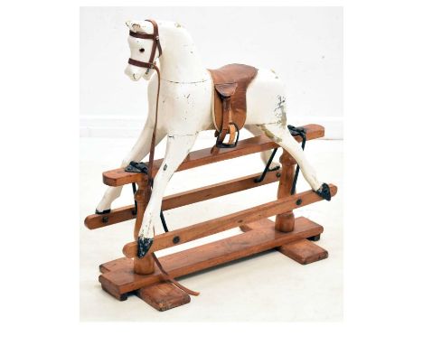 Small early 20th century white painted wooden rocking horse, with glass eyes and brown leather saddle, 74cm x 78cm high (over