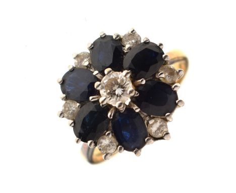 Sapphire and diamond 18ct gold flower cluster ring, the six oval sapphires forming the petals, with smaller diamonds inbeween