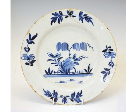 Mid 18th century Delftware plate, probably Bristol, painted with a stylised tree and rockwork, 22cm diameter