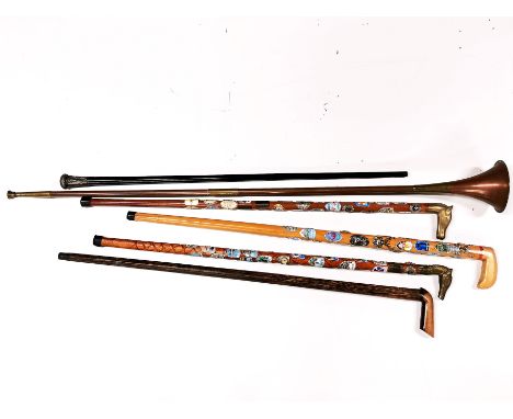 A hallmarked silver topped walking cane, a coconut wood walking stick, a copper and brass post horn and three walking sticks 