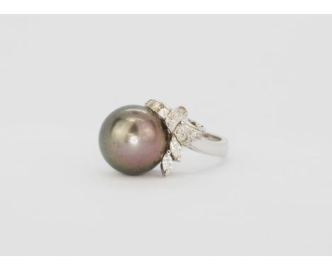 A white metal (tested 18ct gold) ring set with a South Sea black pearl and marquise cut diamonds, (N).