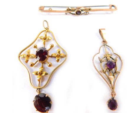 An Edwardian 9ct gold and garnet pendant, a similar 9ct gold and amethyst pendant and a 9ct gold and amethyst bar brooch, 5.0