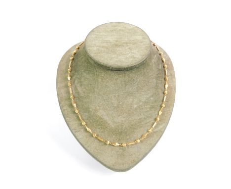 A 20ct gold neck chain, formed of rhomboid, ball and rectangular links, on a snap clasp, 14.7g.