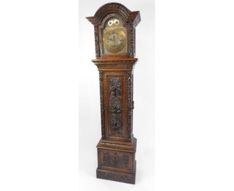 An oak longcase clock, the break arch brass dial with chapter ring bearing Roman and Arabic numerals, subsidiary seconds, str