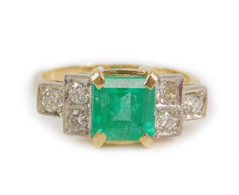 An Art Deco style 18ct gold emerald and diamond ring, of stepped design, the central square cut emerald approx 1.25cts, flank