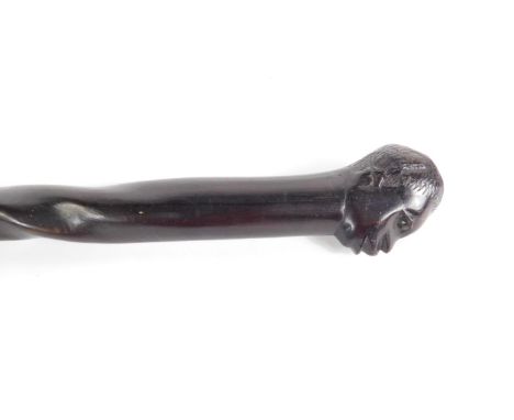 An African carved ebony stick, with a tribal head terminal and spiral twist shaft, 95cm L.