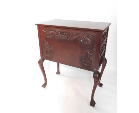 An Arts &amp; Crafts style mahogany chest, the front carved with Celtic dragons, with three drawers to each side, carved with