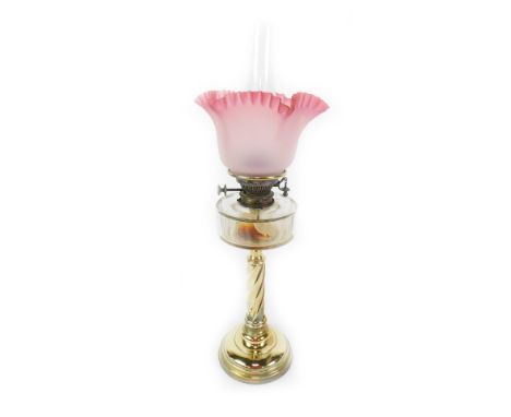 A Hinks's Duplex brass oil lamp, with a faceted clear glass reservoir and cranberry glass frilled shade, with chimney, 69.5cm