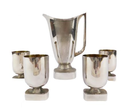 A silver five piece water or wine set, with gilt interior and textured banding, comprising jug and four goblets, Dorothy Budd