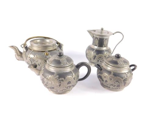 A Wen Hua Shun pottery three piece tea set, with pewter over lay, decorated with dragons, 190 North Gate, Wei Hai Wei City, c