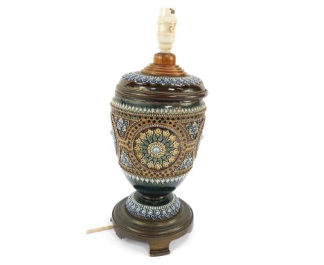 A Doulton Lambeth late 19thC stoneware oil lamp base, converted to electricity, decorated in relief with repeating floral and