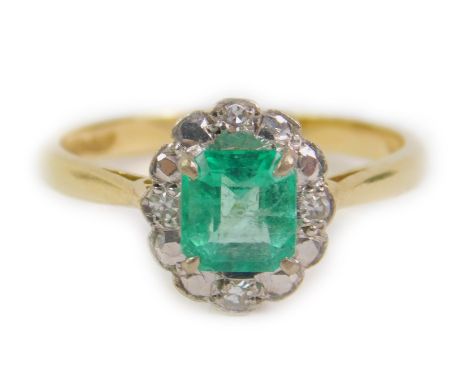 An 18ct gold emerald and diamond ring, of oval design, the square cut emerald approx 1ct, size Q, 3.9g.