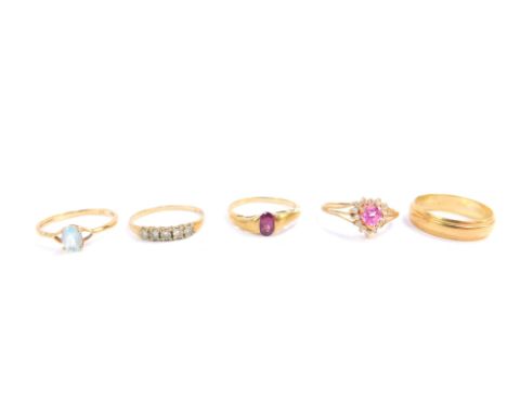 Four 9ct and gem set rings, and a 9ct gold wedding band, size O, 8.0g.
