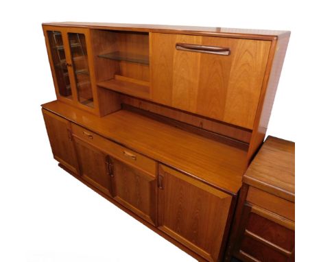 A G-Plan teak cabinet sideboard, the top with two glazed doors enclosing glass shelves, central shelf and drop down drinks ca