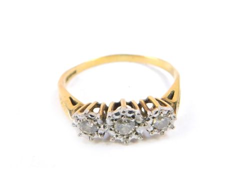 An 18ct gold and diamond three stone ring, in a high claw illusion setting, size T, 2.8g