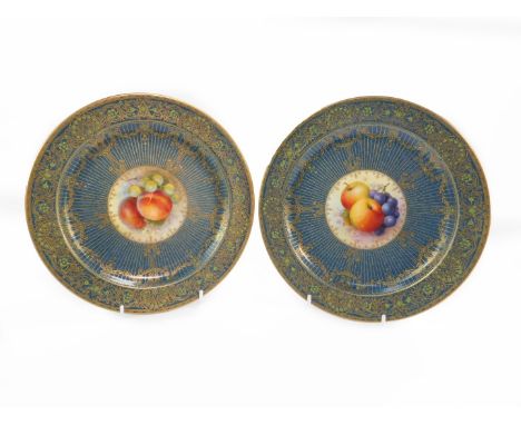 A pair of Royal Worcester porcelain plates painted with fruit by Richard Seabright, signed, circa 1938, against a powder blue