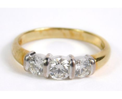 An 18ct gold and diamond three stone ring, approx 0.9ct, size N, 3.7g.