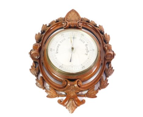 A Victorian walnut wall barometer, with a circular dial, within a scrolling frame with carved acanthus leaves and hairbells, 