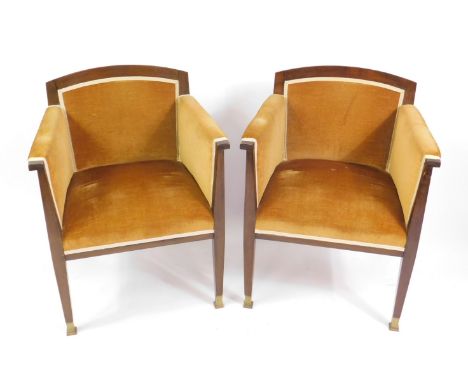 A pair of 20thC reproduction mahogany framed armchairs, upholstered in gold draylon, raised on tapering square legs, on brass