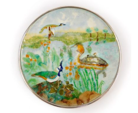 A silver and cloissonne enamel circular dish, decorated with grebes and lapwings, against a river landscape, Dorothy Budd, Lo