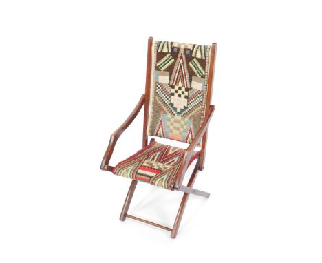 A mahogany steamer chair, upholstered in carpet fabric.