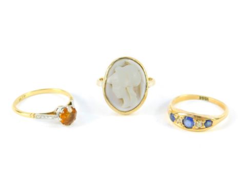 An 18ct gold and sapphire three stone gypsy ring, set with diamonds at intervals, size N, 9ct gold and cameo ring, size P, an